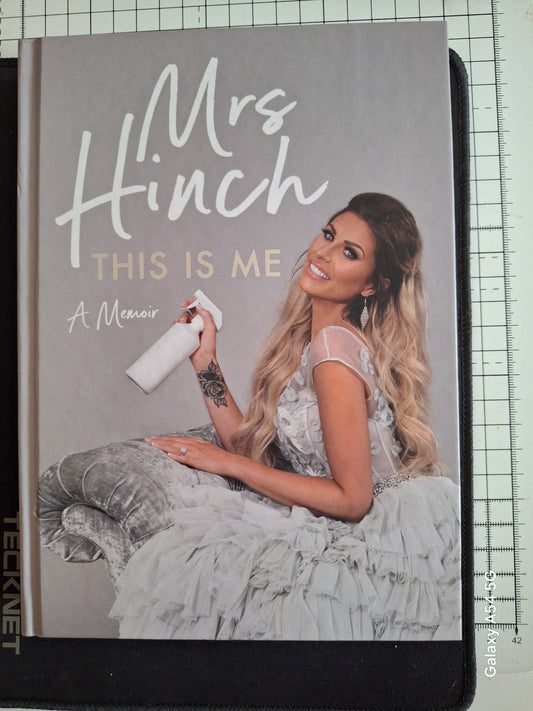 Mrs Hinch memoir book cover featuring Mrs Hinch in a white dress holding a spray bottle