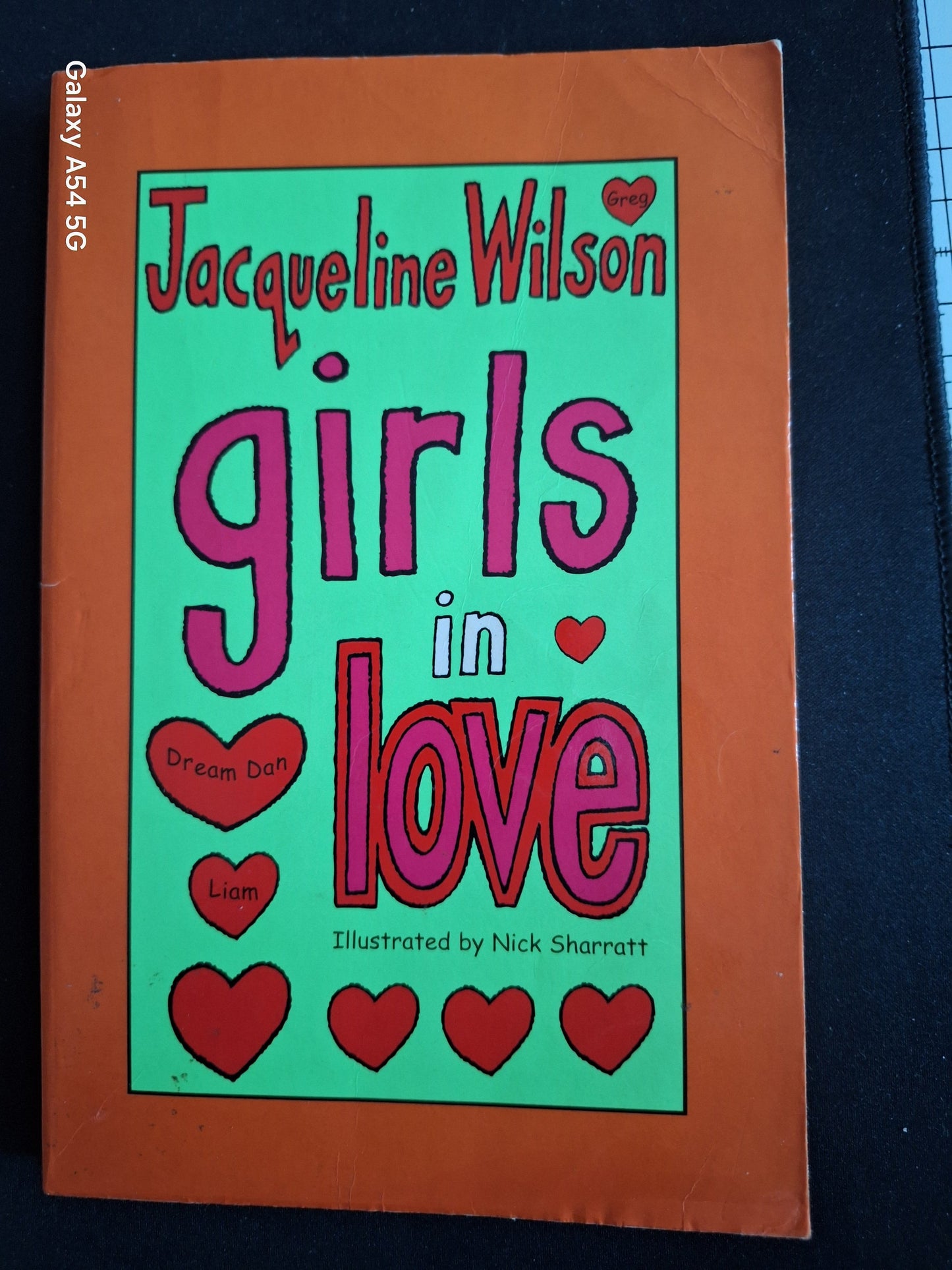 Second hand Girls in Love book by Jacqueline Wilson with orange cover and heart illustrations