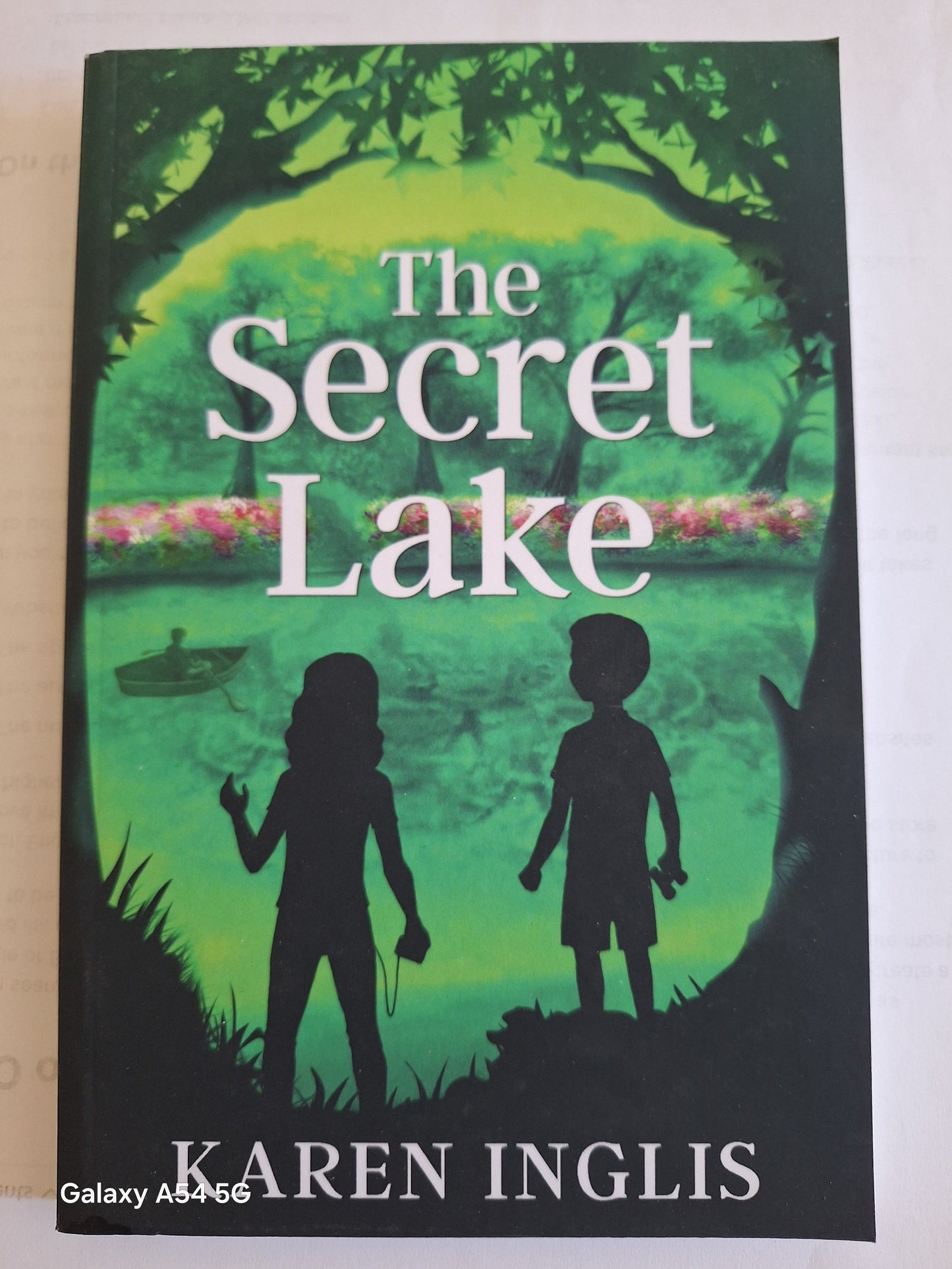 The Secret Lake Karen Inglis book cover featuring two children by a lake surrounded by greenery