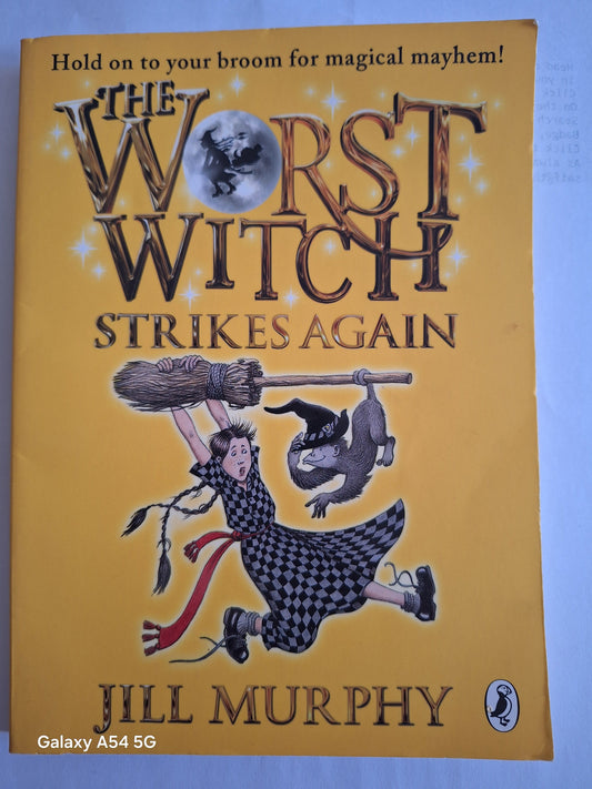 The Worst Witch Strikes Again used book by Jill Murphy featuring a witch with a broom and a cat